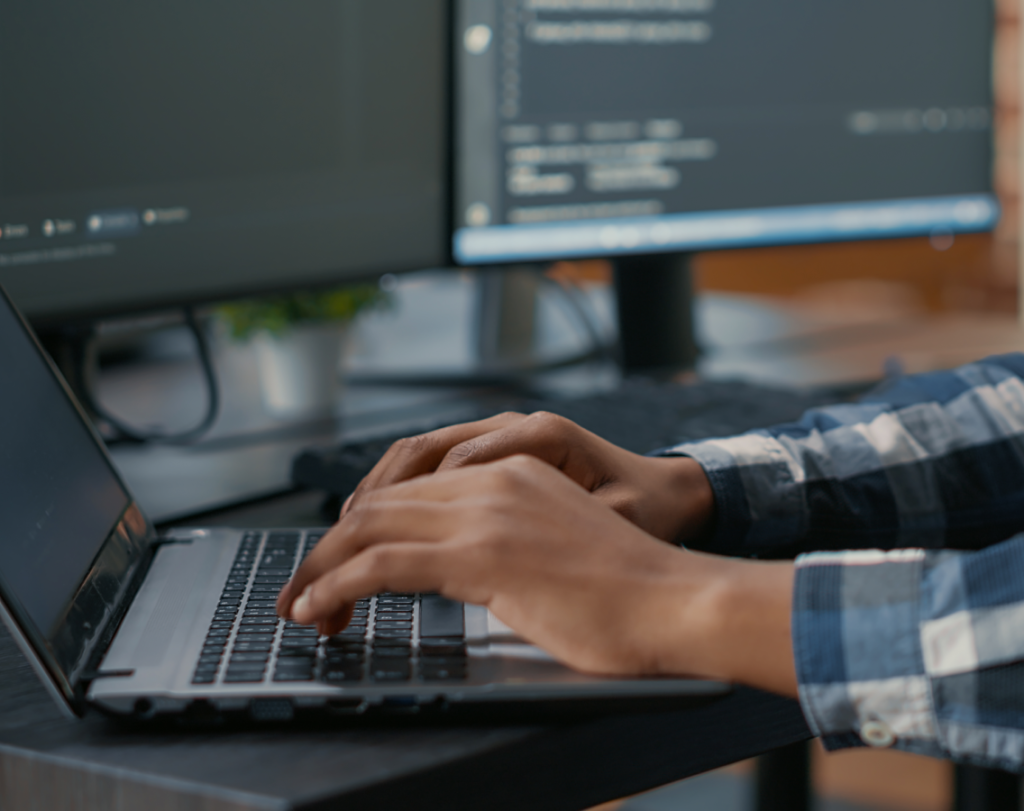 A Web Developer typing on kyboard in Dubai office.